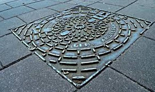 manhole cover on the sidewalk